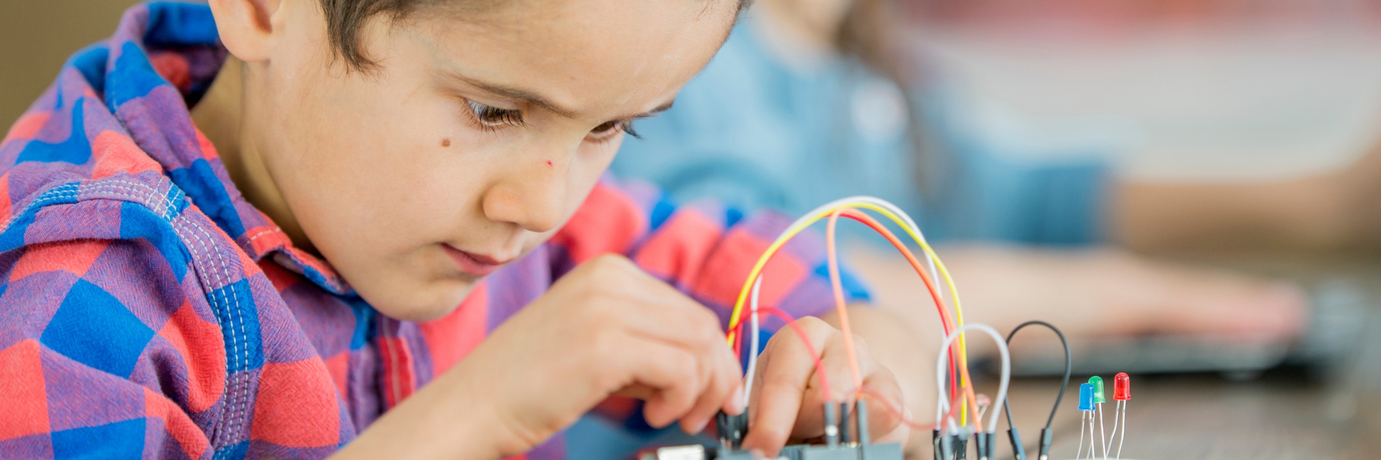 Boy looking intently at some science equipment