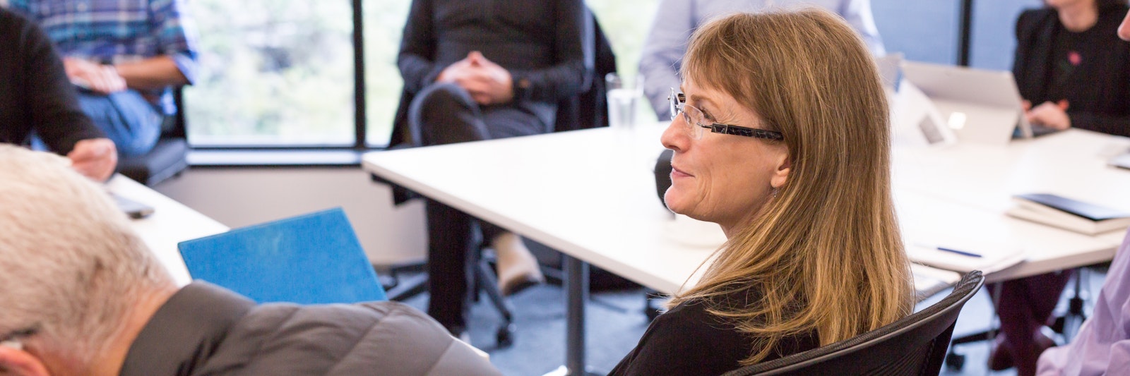 Close up of a woman sitting in a seminar