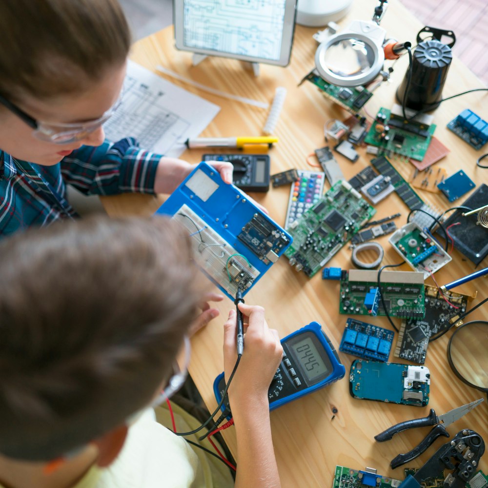 Two students working on electronic components