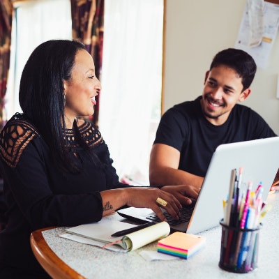 Man and a woman sit at a table, talking