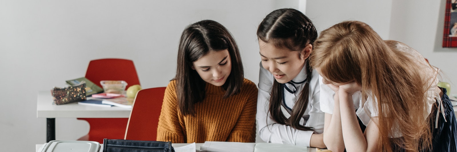 Three girls reading at school