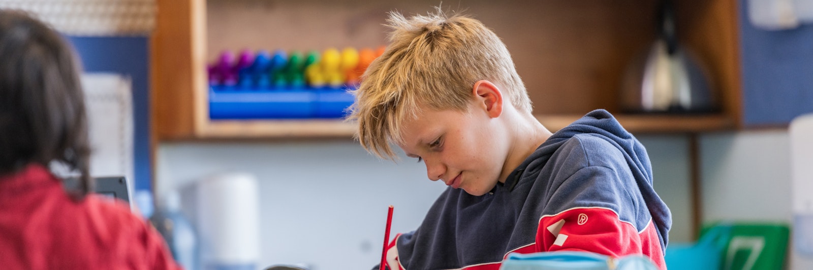 Young boy reading and writing