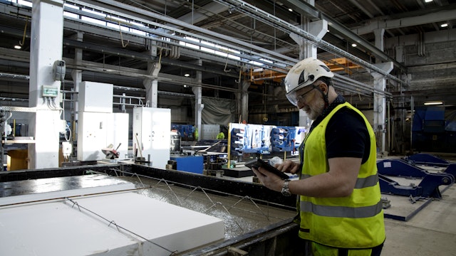 Industry worker using checklist in Boards on Fire on his tablet.