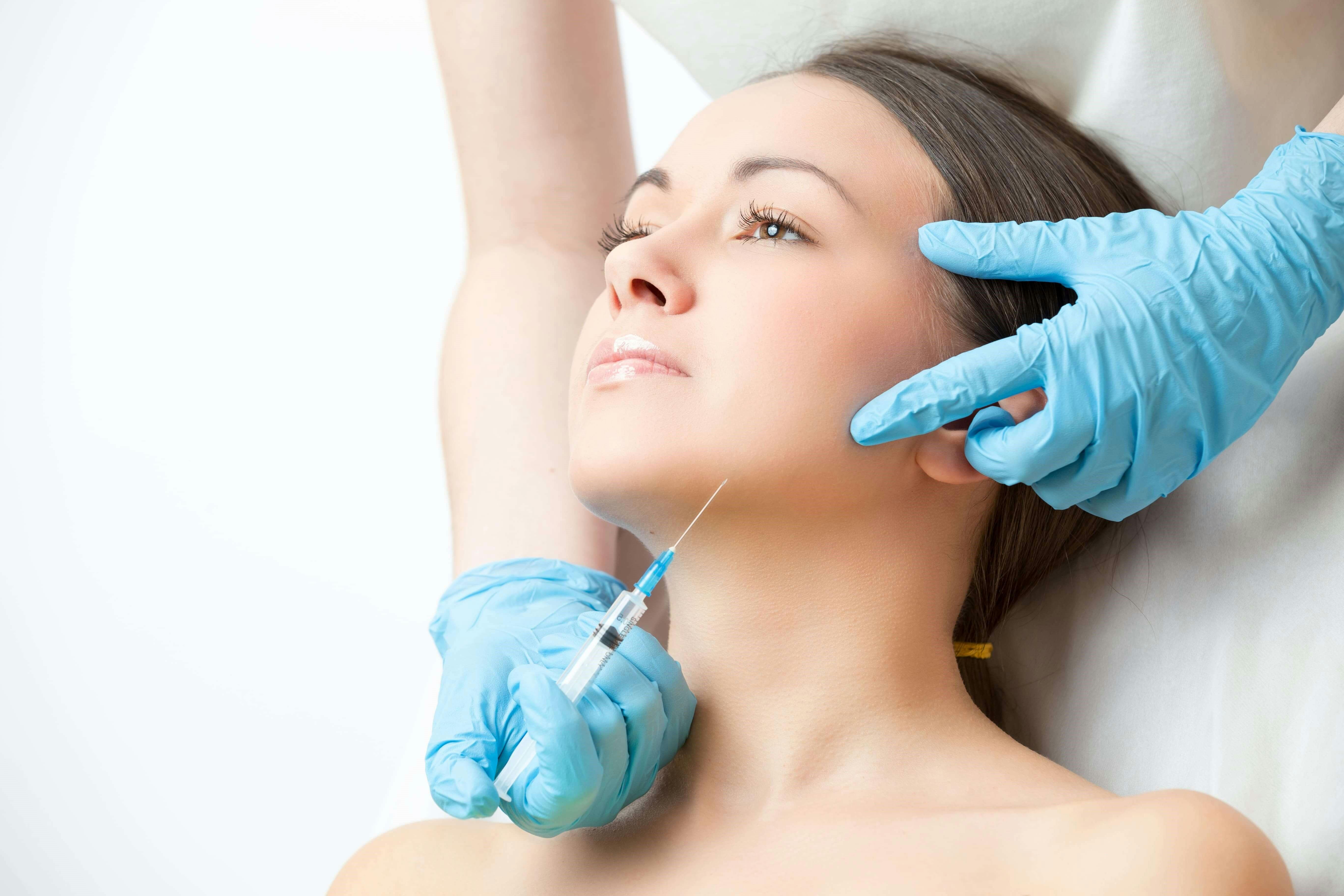 Woman getting an injection in her jaw