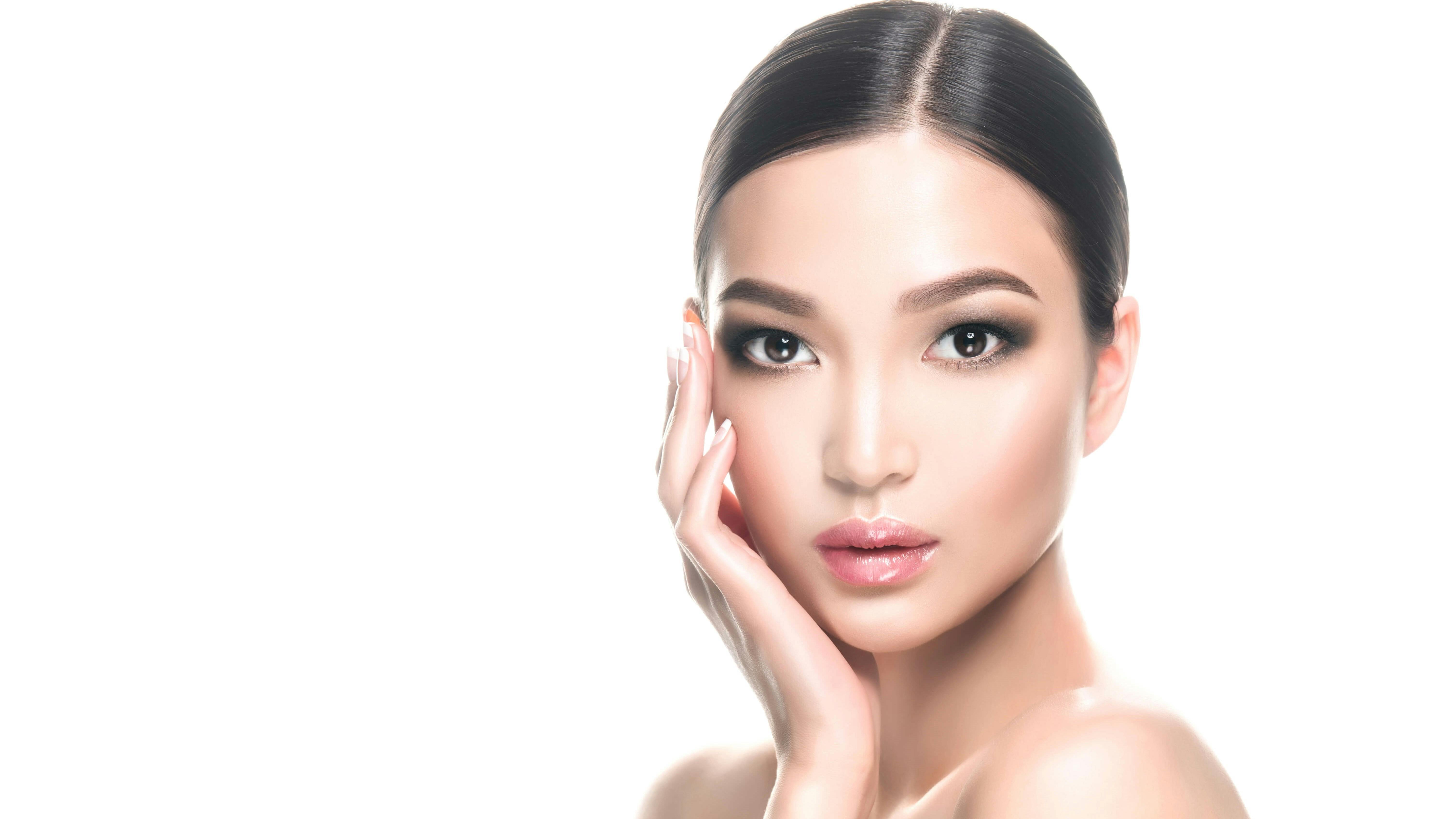 Woman holding hand up to the side of her face