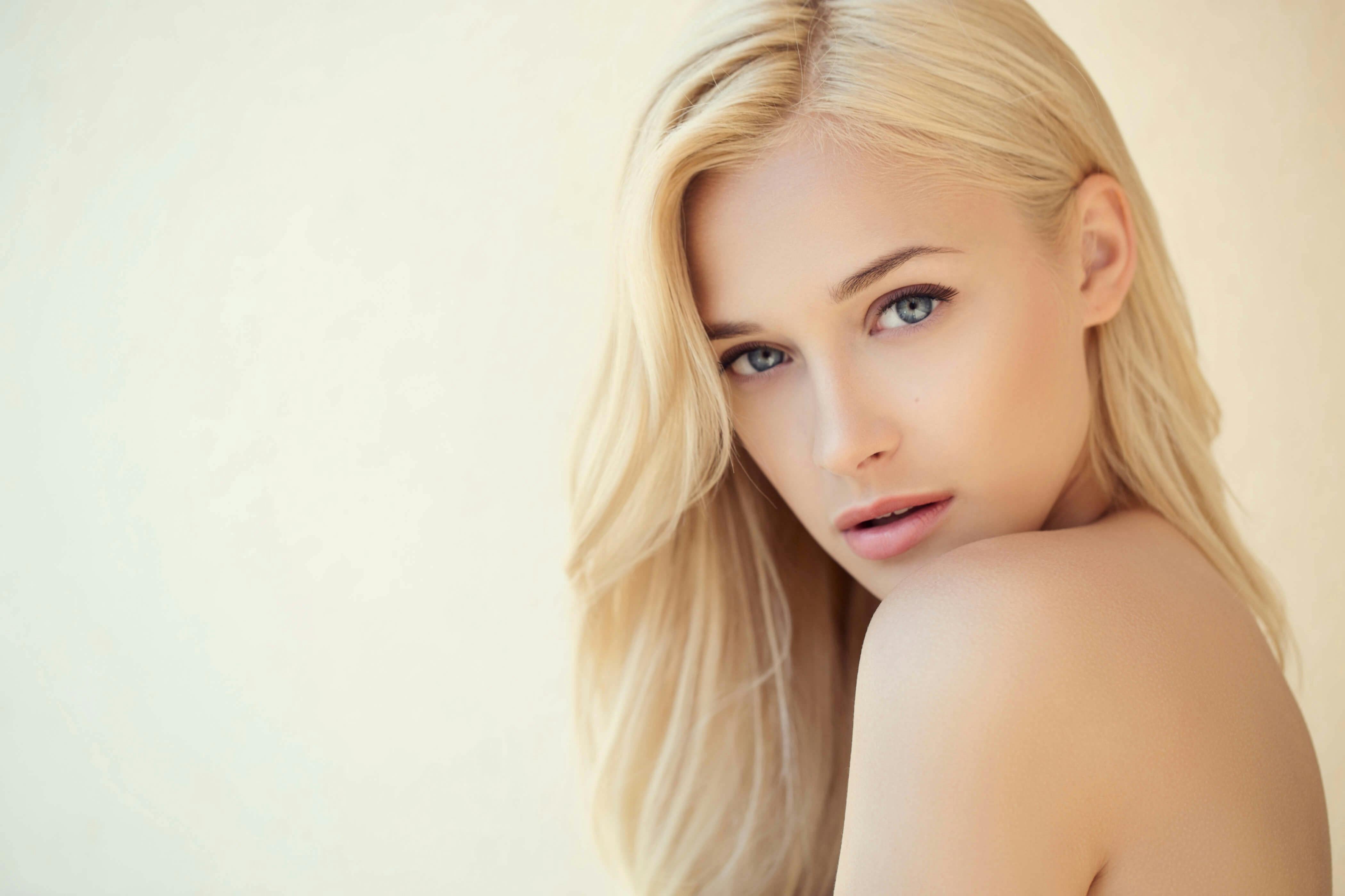 Blonde woman looking over her shoulder