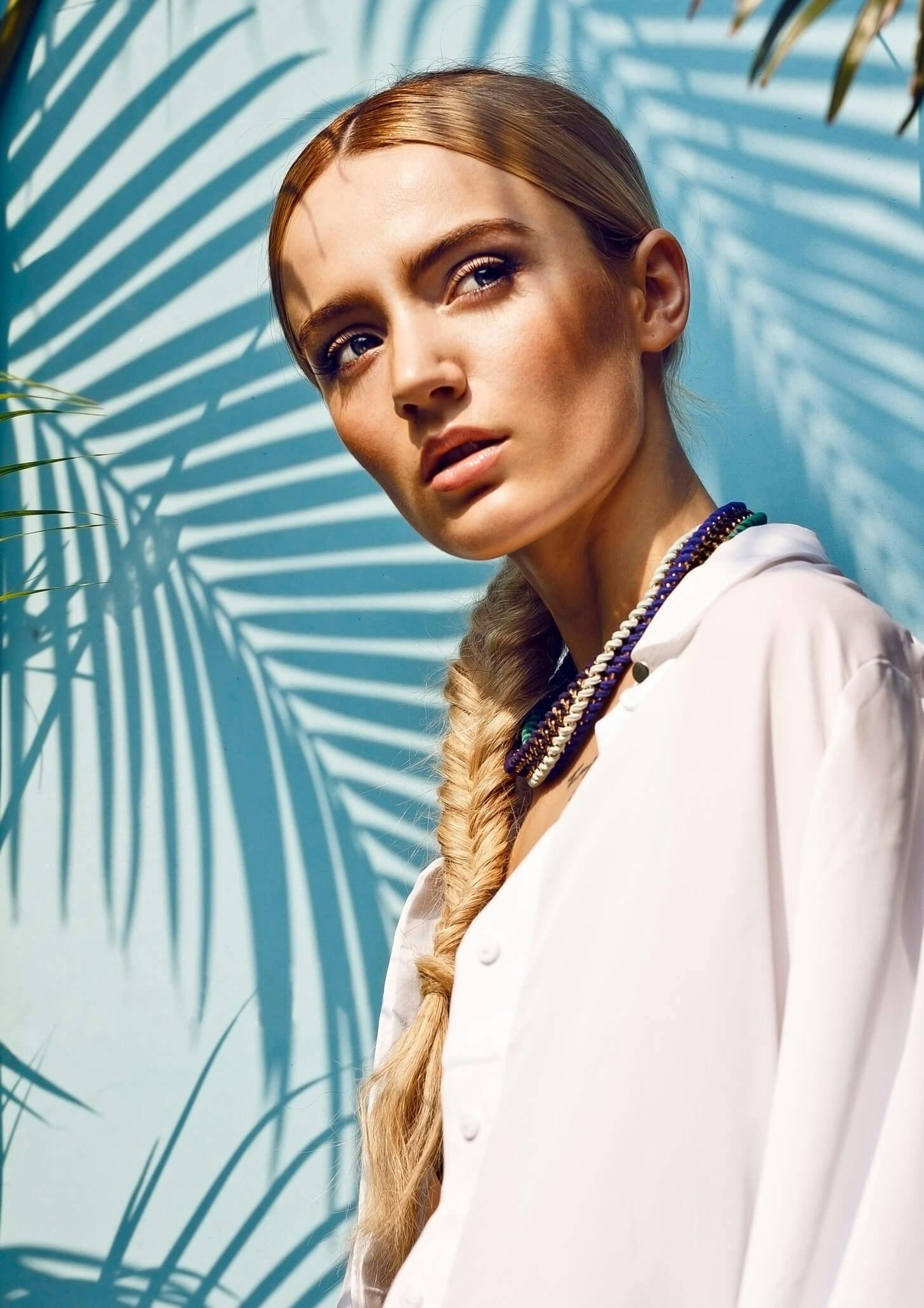 Woman in white blouse looking to the side