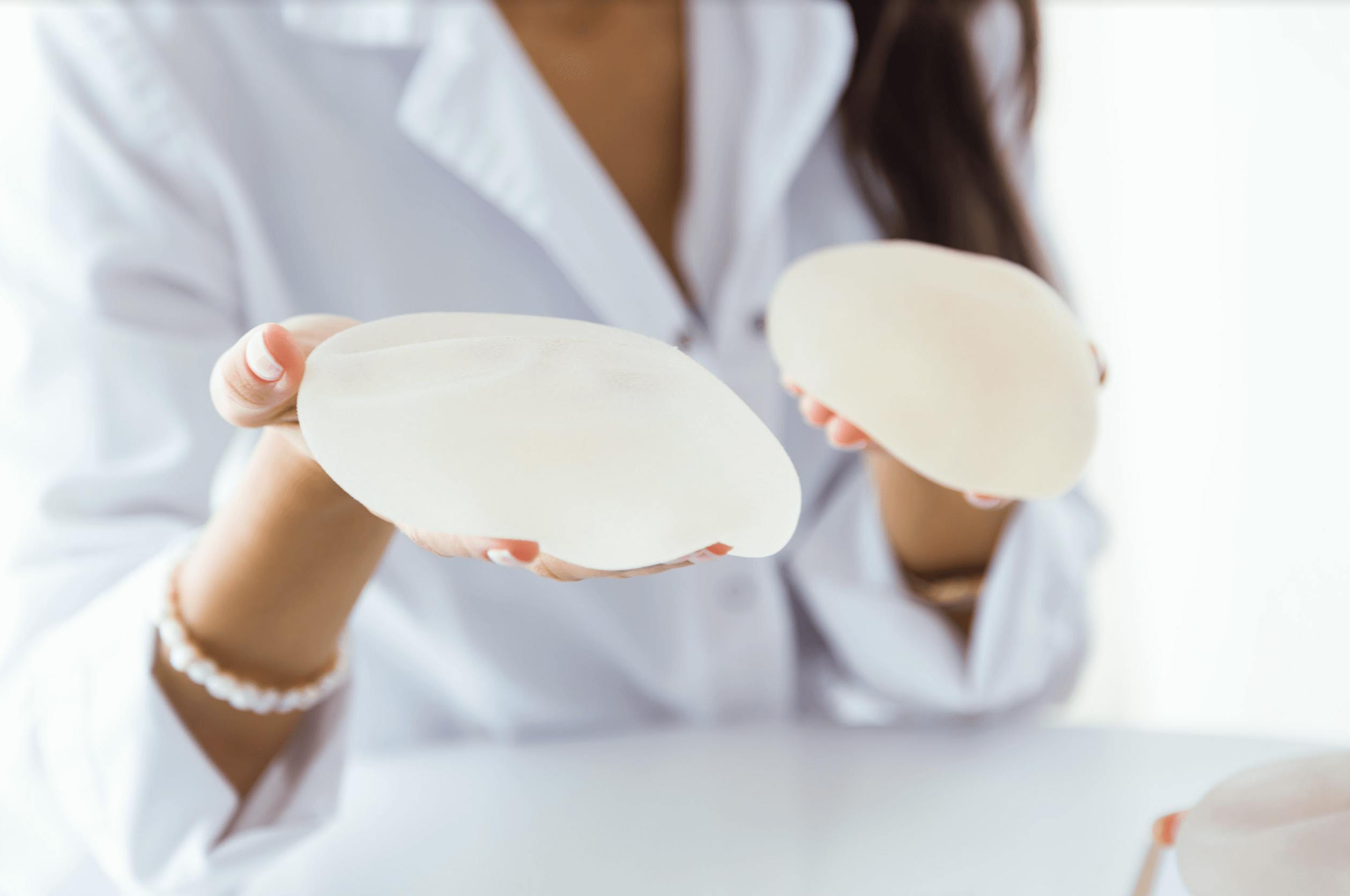 Woman holding breast implants
