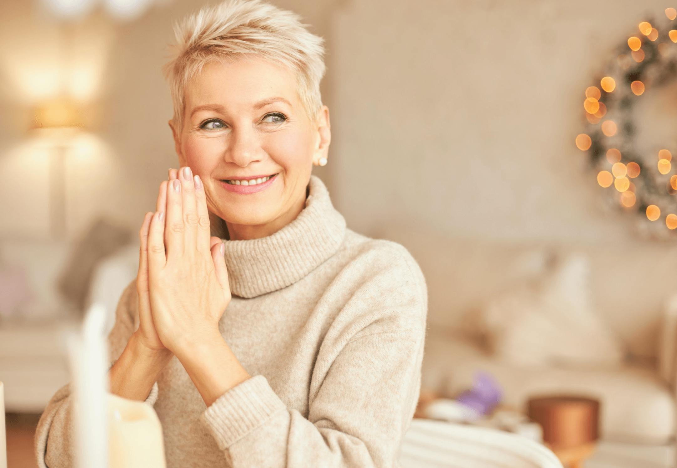 Older woman smiling with hands together
