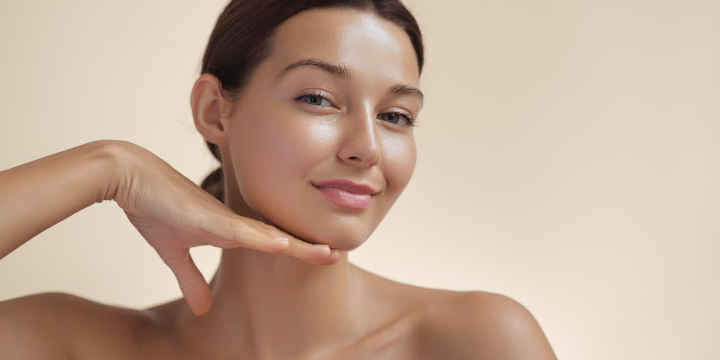 Woman holding her hand to her chin posing
