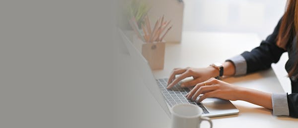 person typing on their laptop