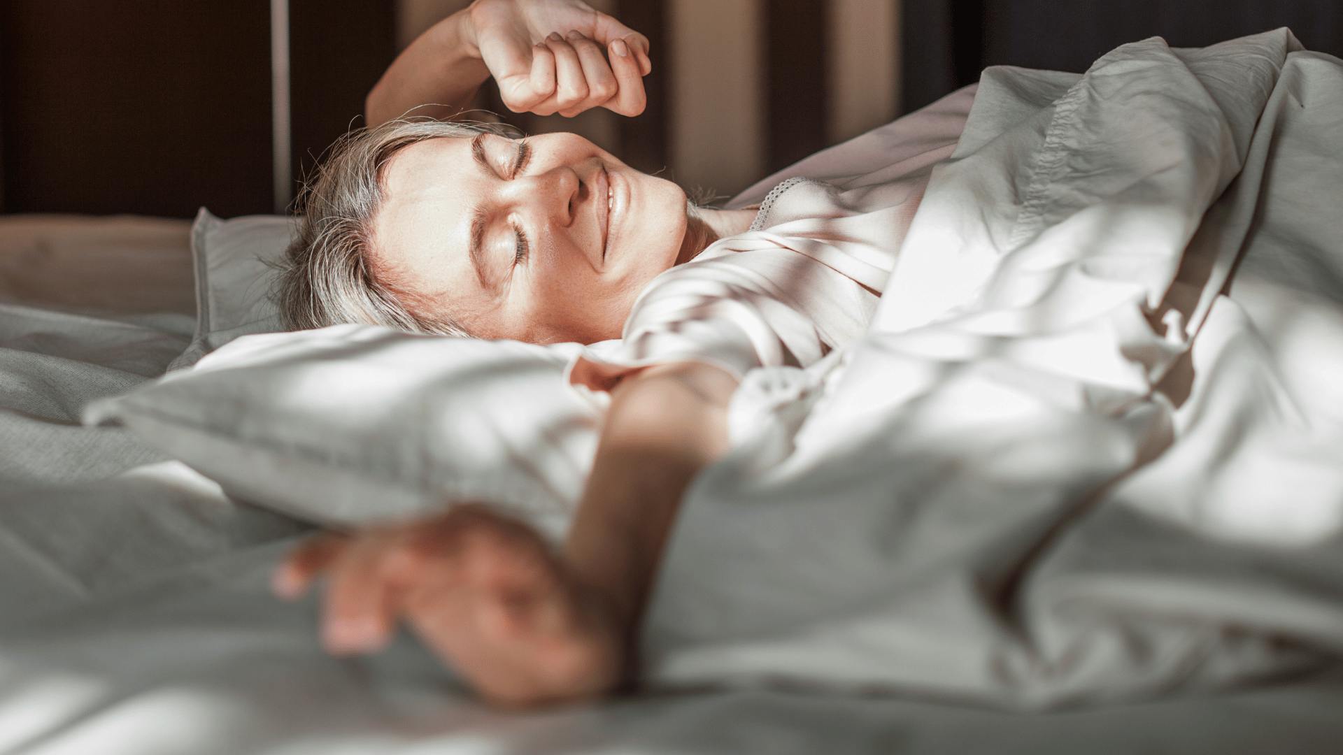 Woman in bed stretching