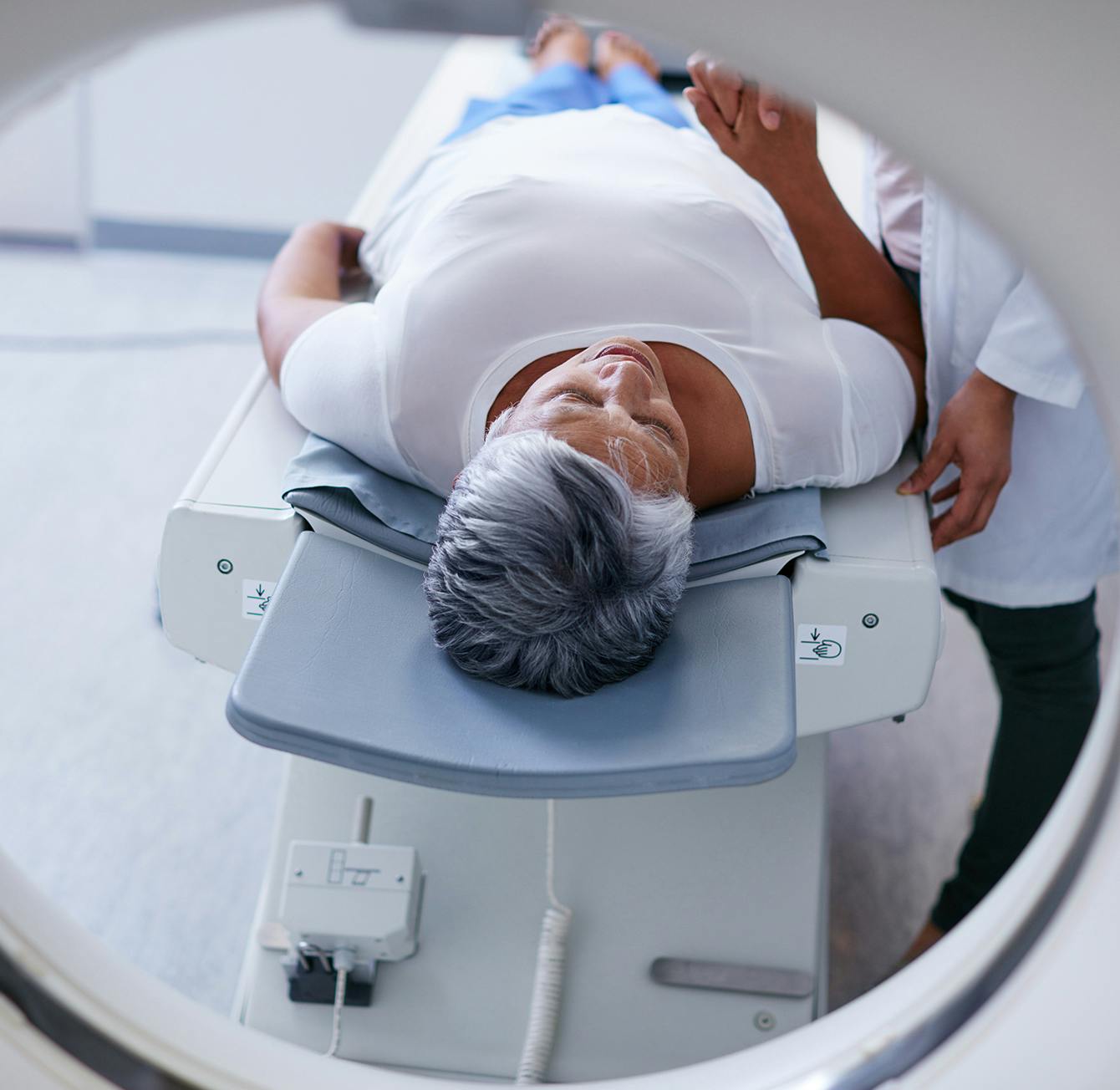 Woman going into CT machine for imaging