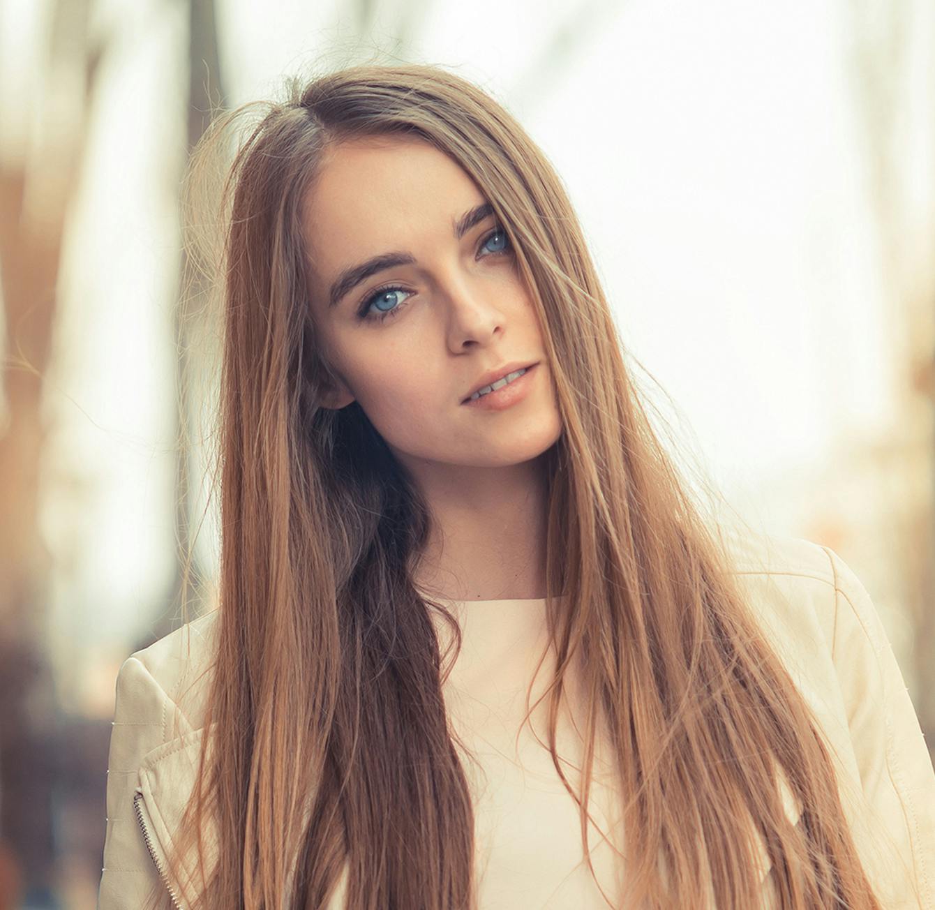 Headshot of a woman tilting her head