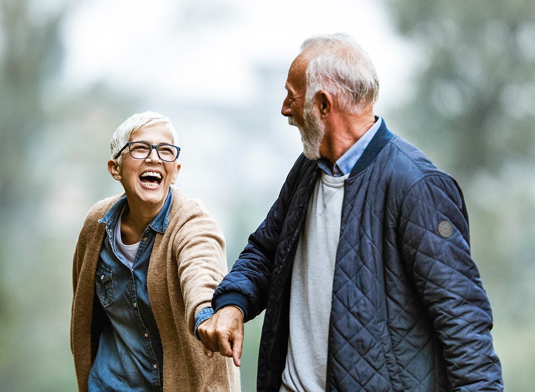 Man pulling a woman along while they are walking
