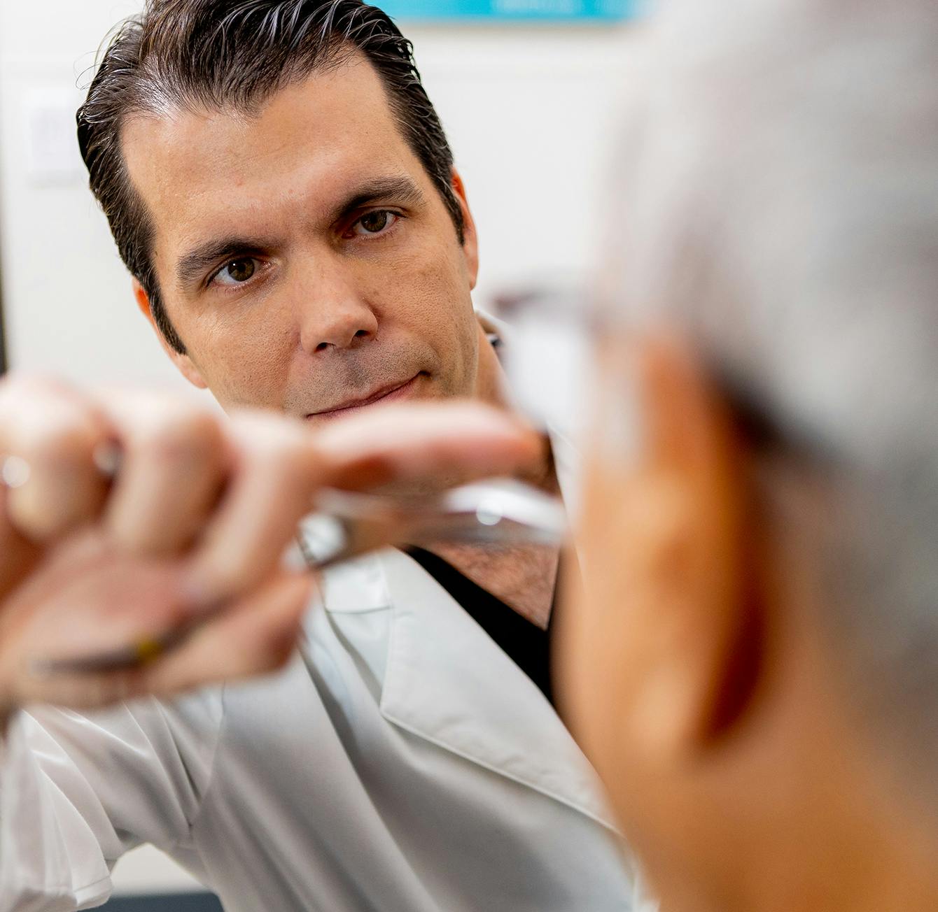 woman getting her eye examined by a doctor
