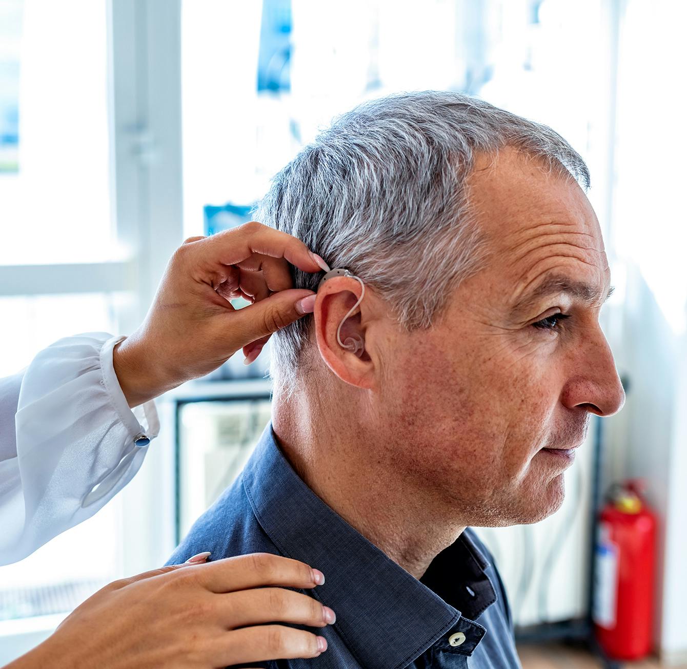 man getting his ear looked at by a doctor