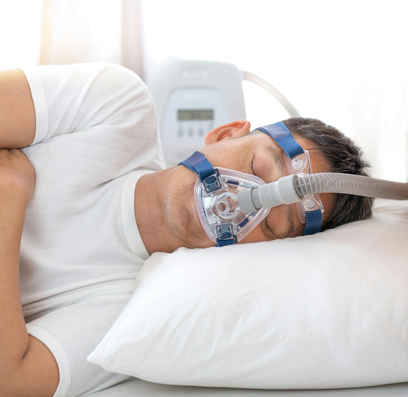 man laying in bed with oxygen mask on