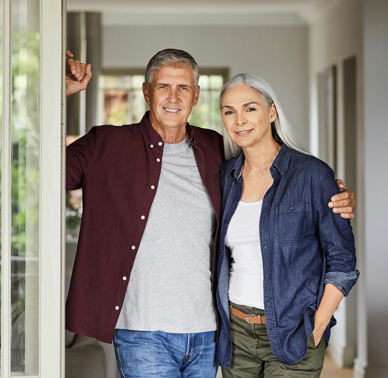 Man and woman standing in a doorway with their arms around each other