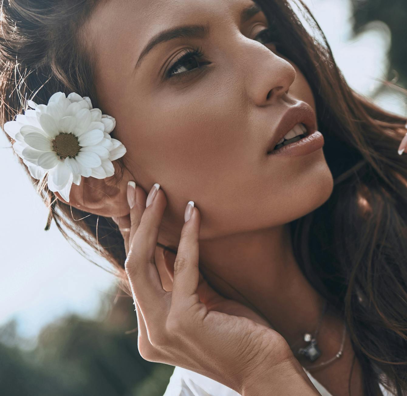 woman with a flower in her hair posing for a picture