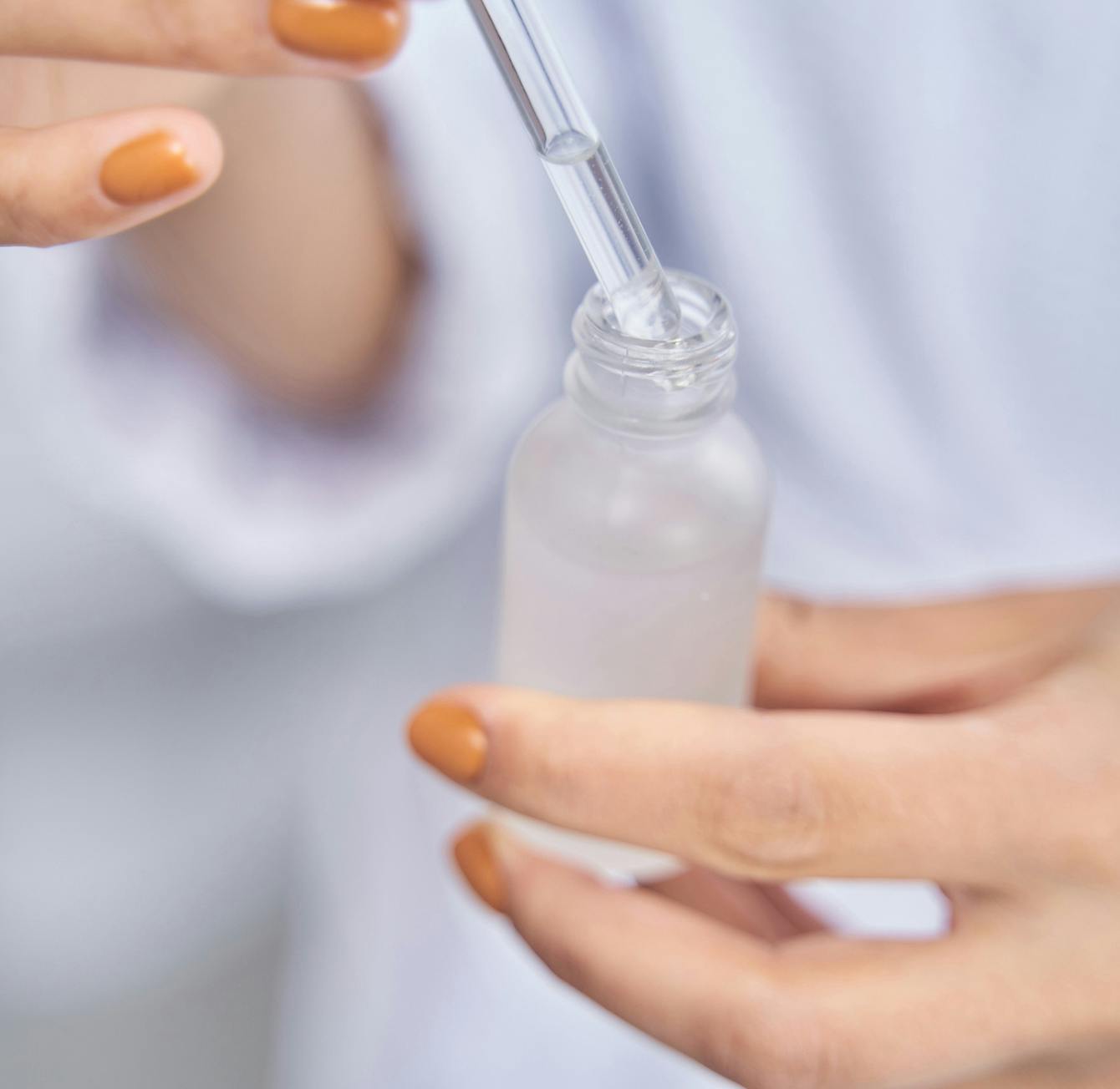 someone is holding a bottle of liquid with a straw in it