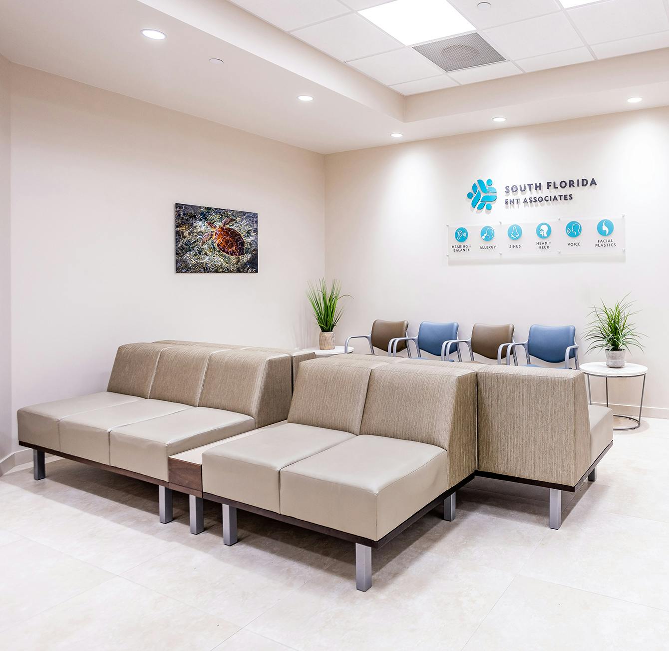 there is a couch and a chair in a waiting room