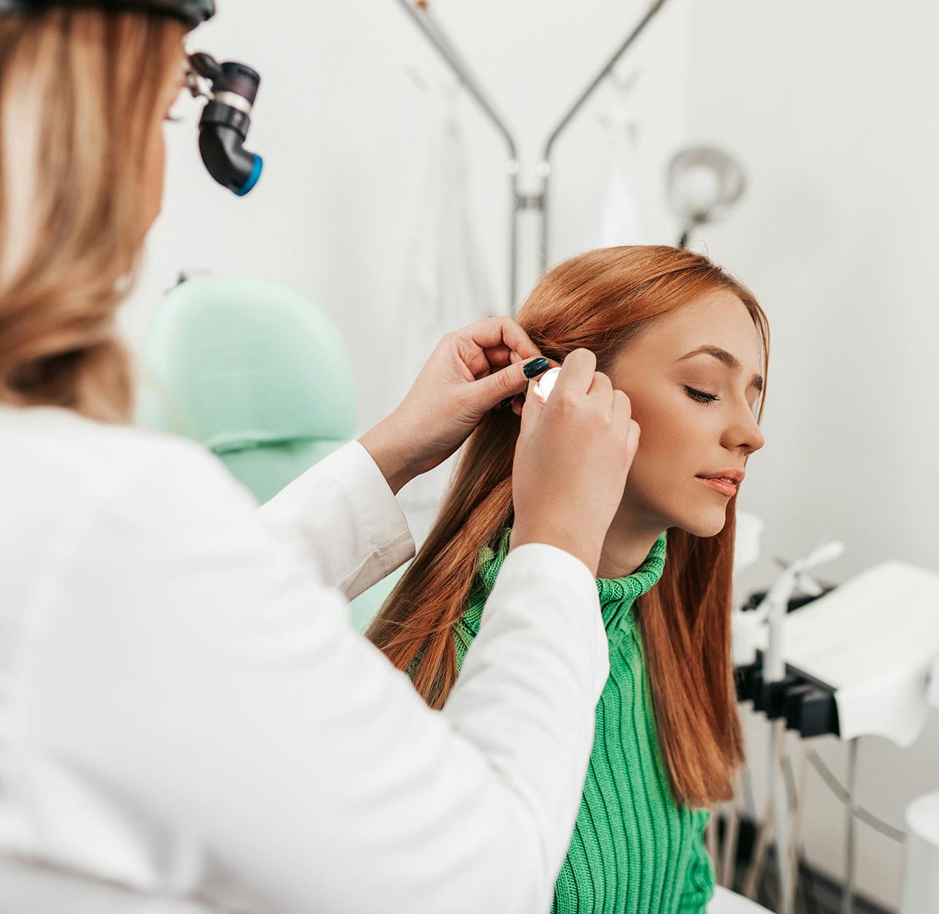 woman getting her hair done by a doctor