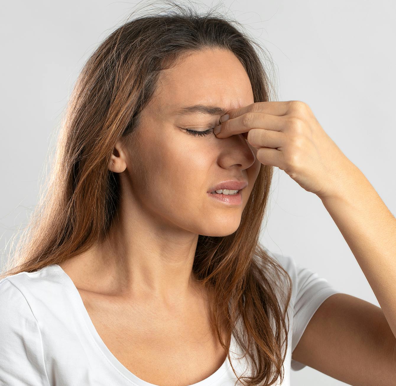 there is a woman holding her eye with both hands