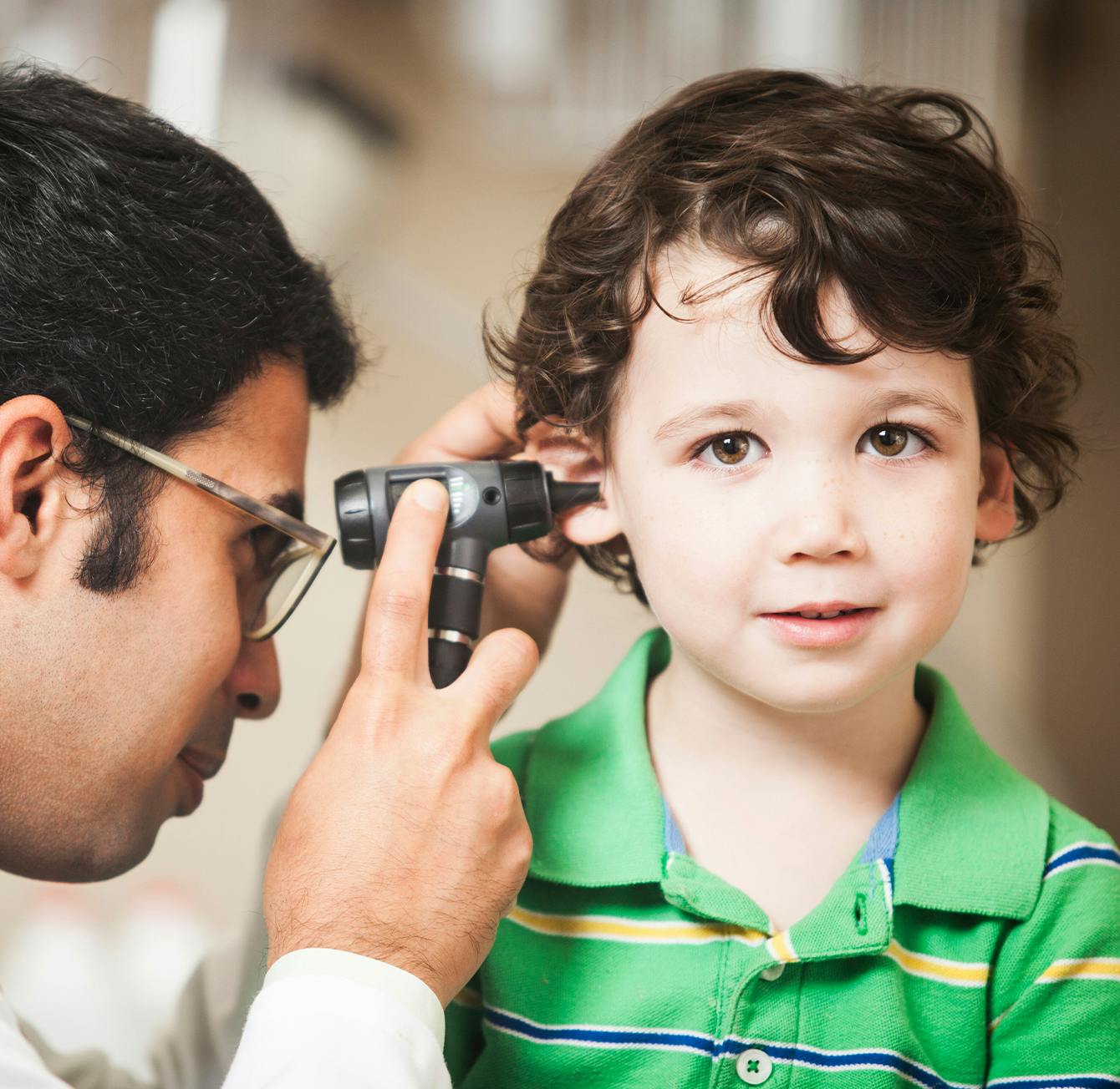 Doctor looking into a child's ear