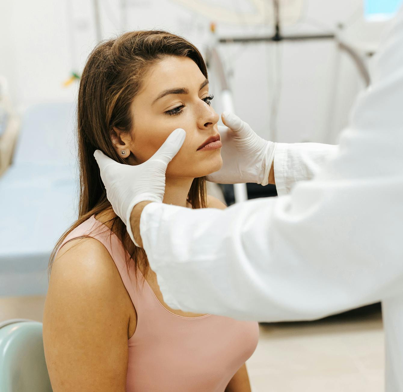 woman getting her nose examined by a doctor