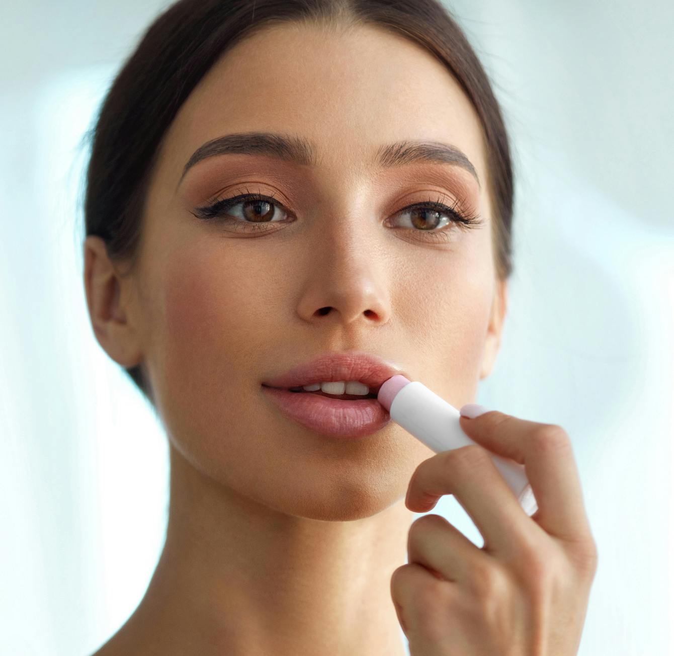 there is a woman brushing her teeth with a toothbrush