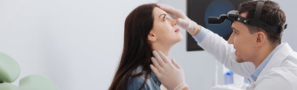 Doctor Examing Patients Nose
