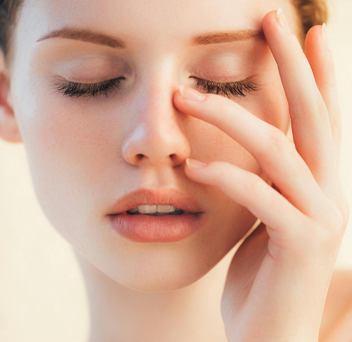 Woman with her hand on her face