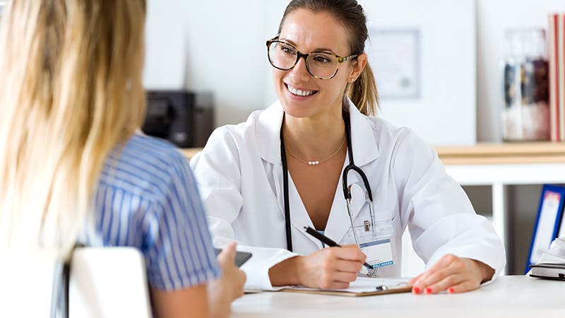 Female physician with female patient