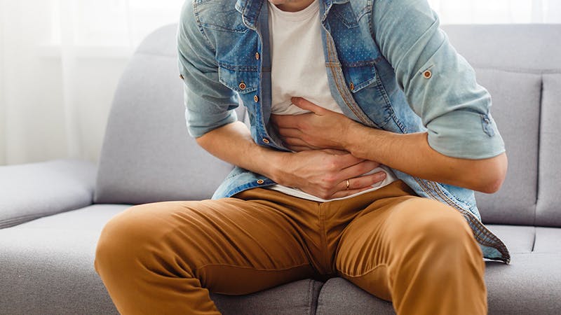 Man holding stomach in pain