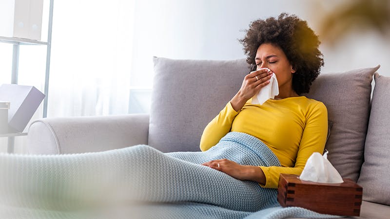 Woman holding tissue to her nose