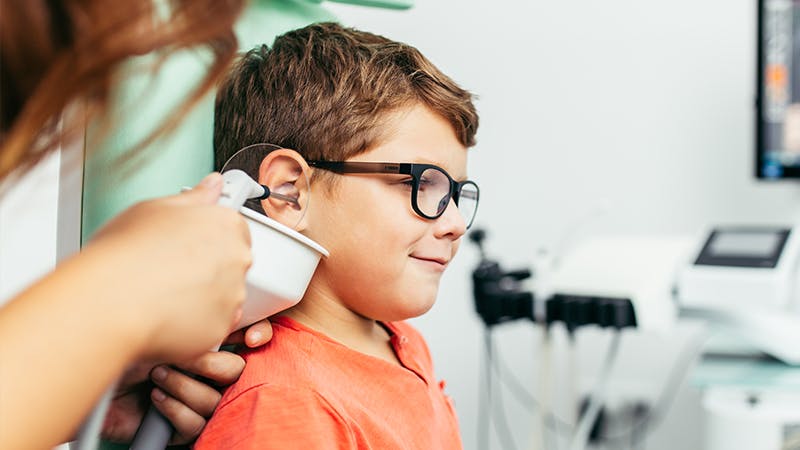 Child receiving treatment on his ear. 