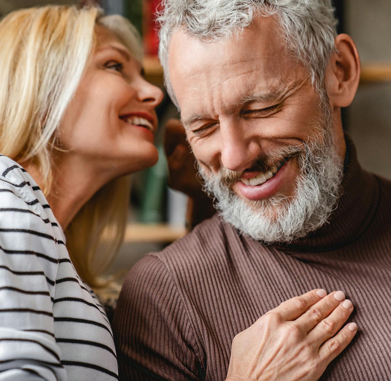 Woman whispering in a man's ear