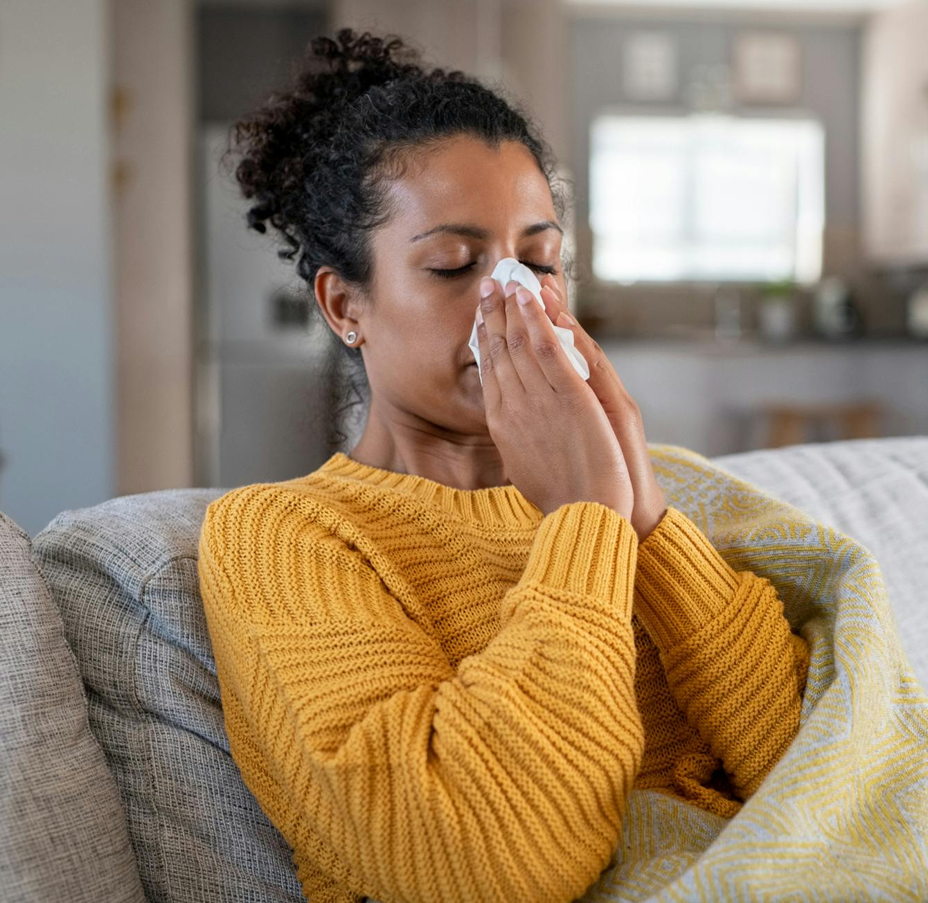 Woman blowing her nose