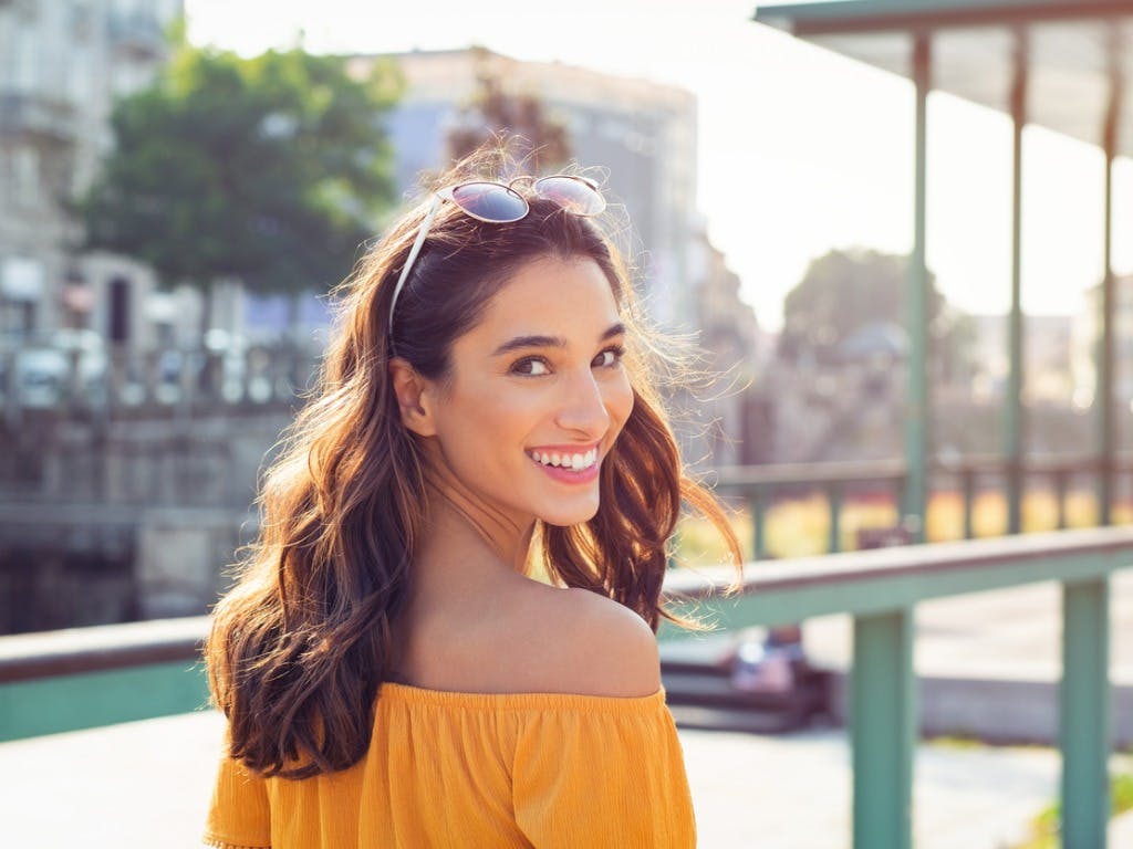 Women With Warm Smile Walking Outside