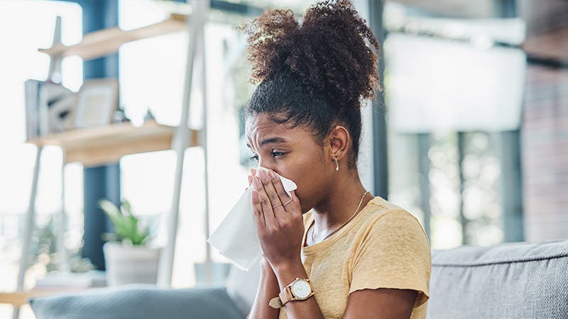 Woman blowing her nose