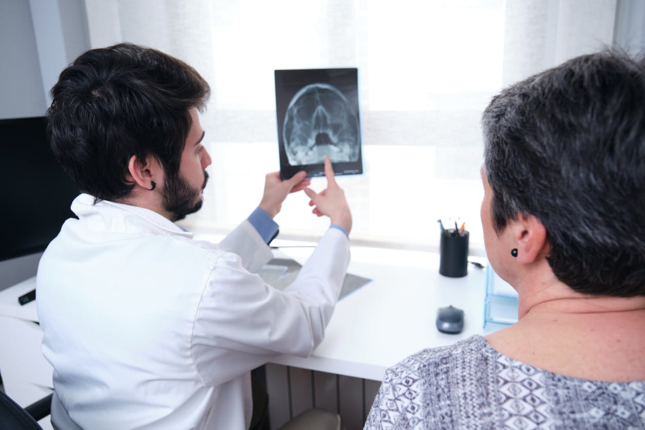 Doctor and patient looking at an x-ray of the head and sinuses