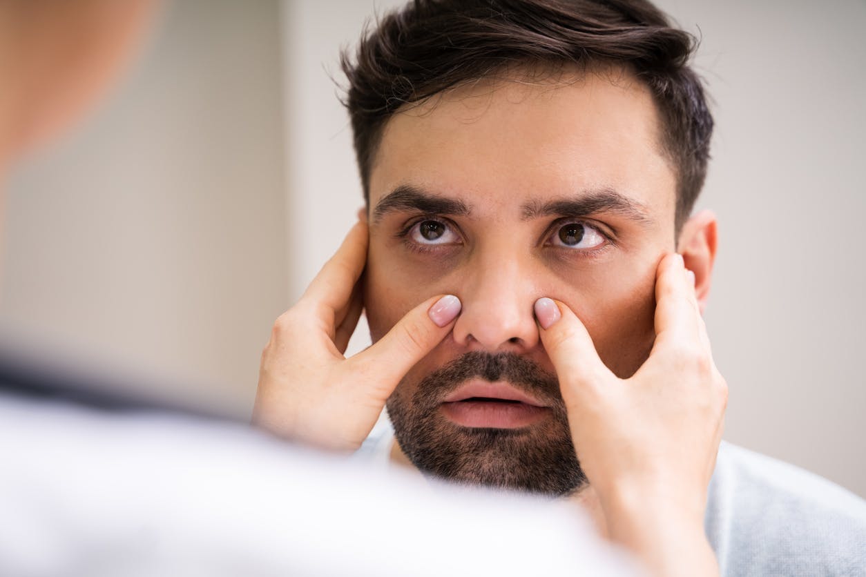 Doctor touching a patients face