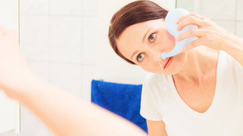Woman cleaning out her nose