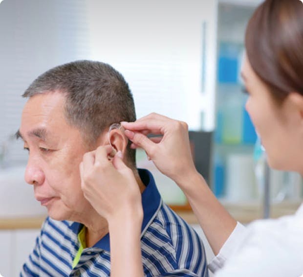Man being fitted for a hearing aid