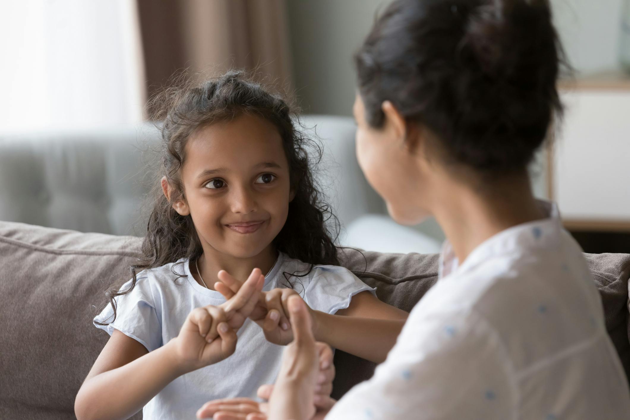 5-year-old deaf girl signing to her mother