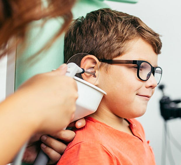 Little boy getting his ears cleaned