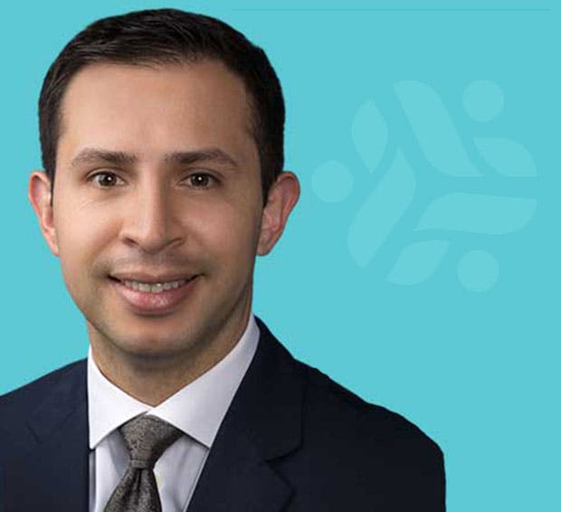 man in a suit and tie smiling at the camera