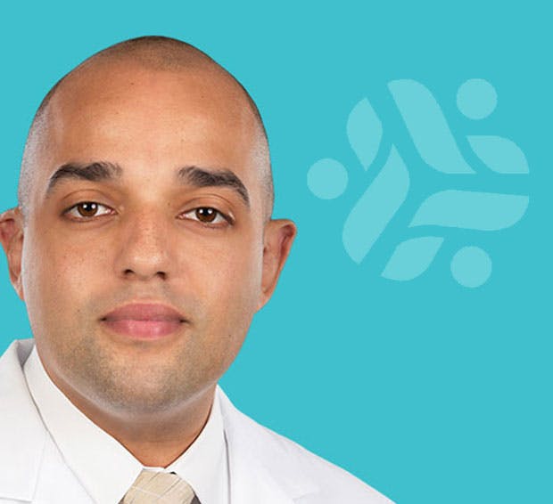 man in a lab coat and tie with a blue background