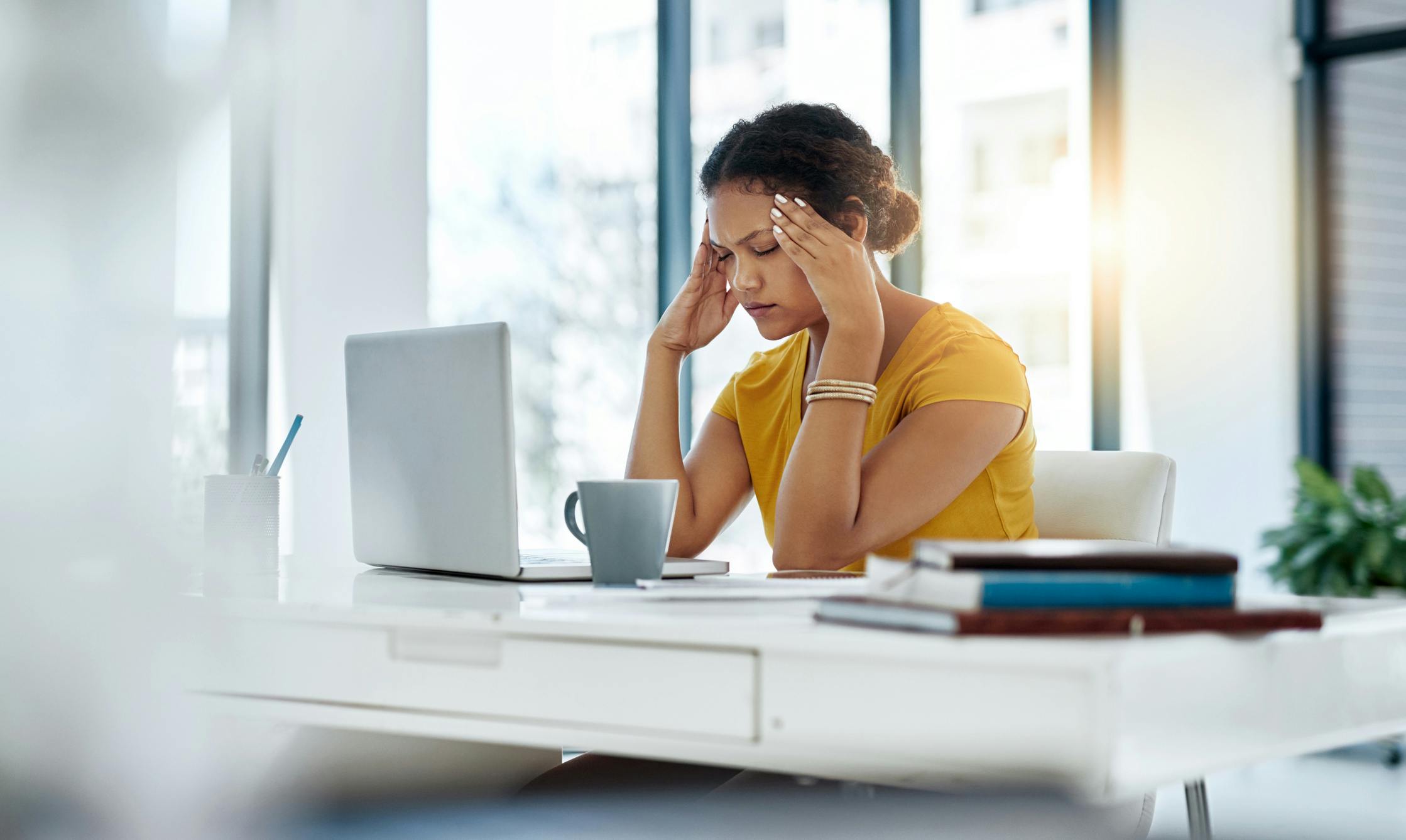 Stressed out business woman in yellow blouse